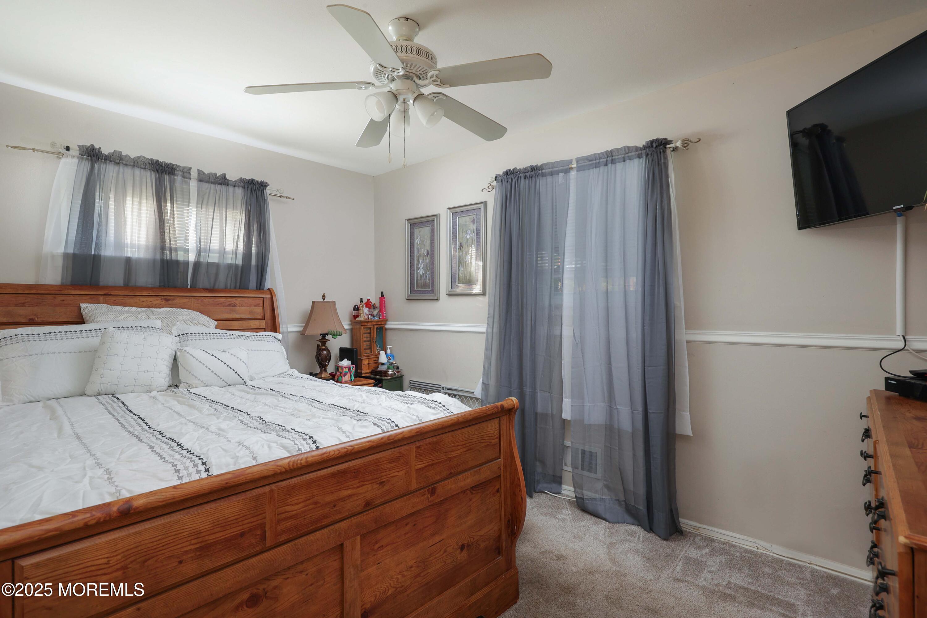 51 Alan Terrace Howell, NJ 07731 - Photo 17 of 32 a bedroom with a bed and a flat screen tv