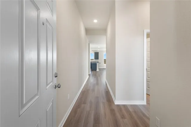 a view of a hallway with wooden floor
