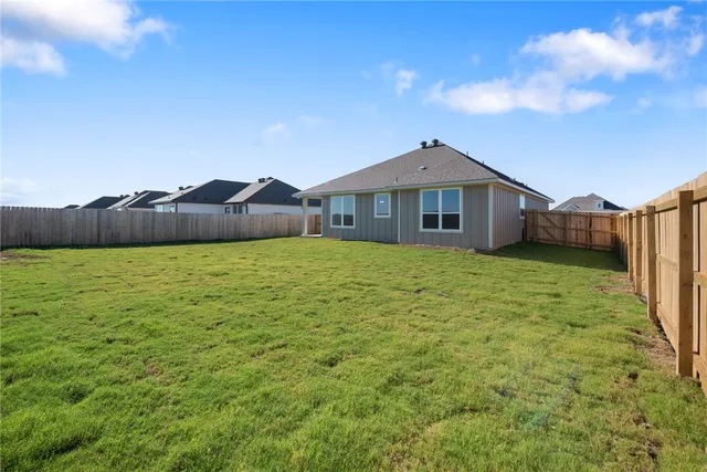 a large house with a big yard and large trees