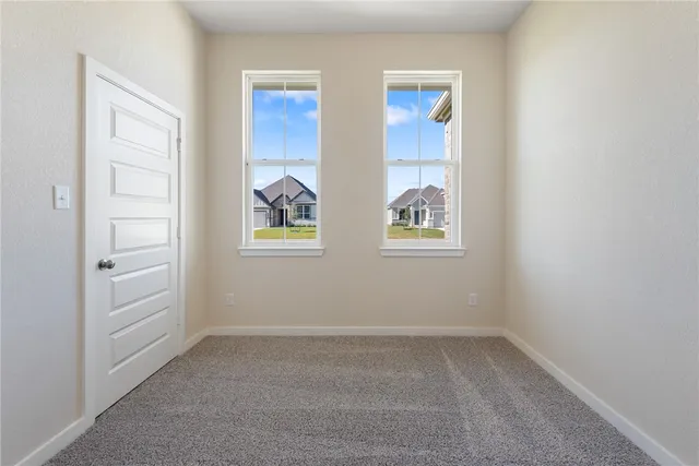 an empty room with windows and closet