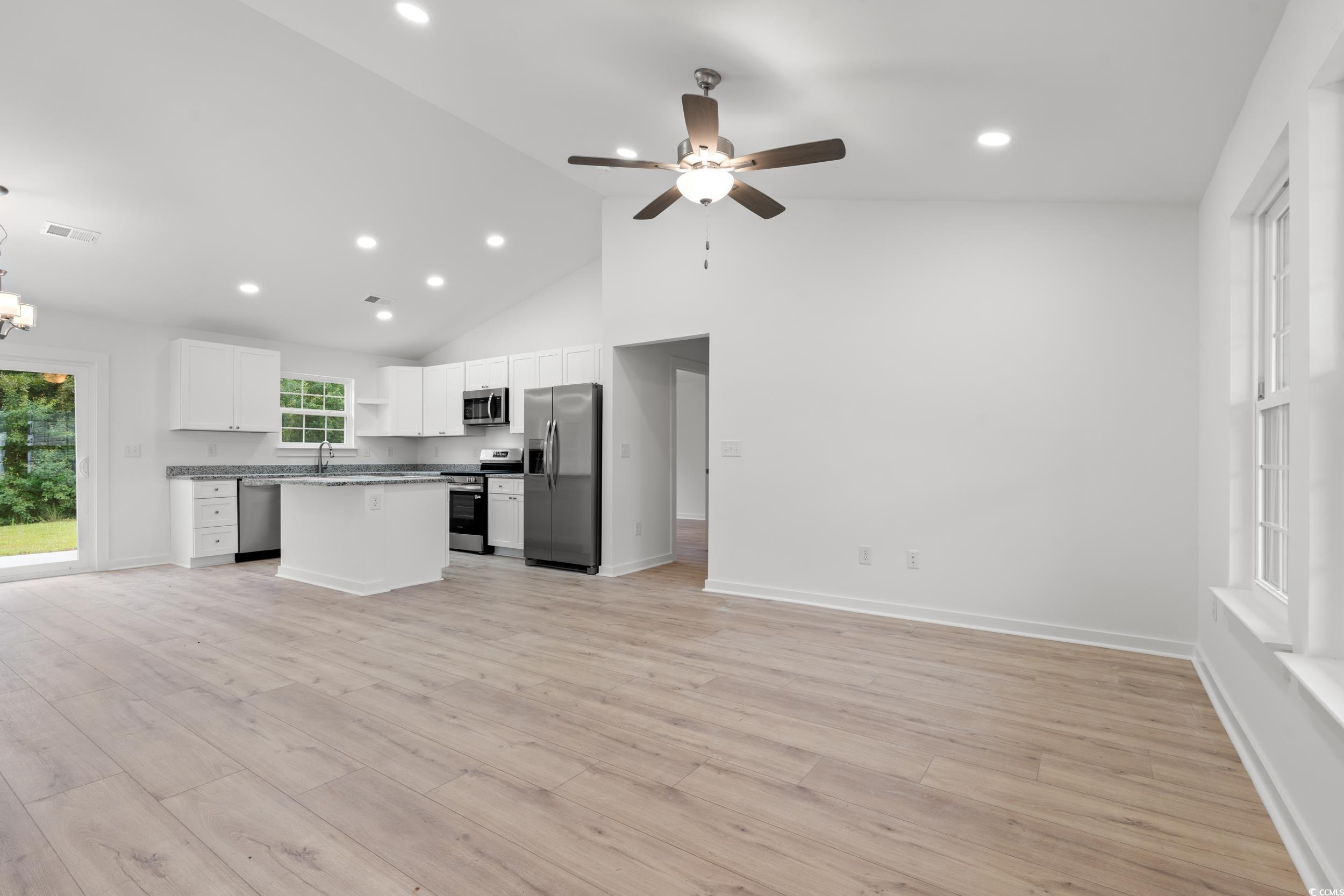 2827 Biscane Court Conway, SC 29527 - Photo 30 of 31 Kitchen featuring open floor plan, white cabinets, light wood-type flooring, open shelves, and a center island