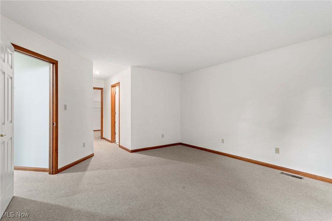 2155 Abbey Road Akron, OH 44312 - Photo 16 of 31 Empty room featuring light carpet and baseboards