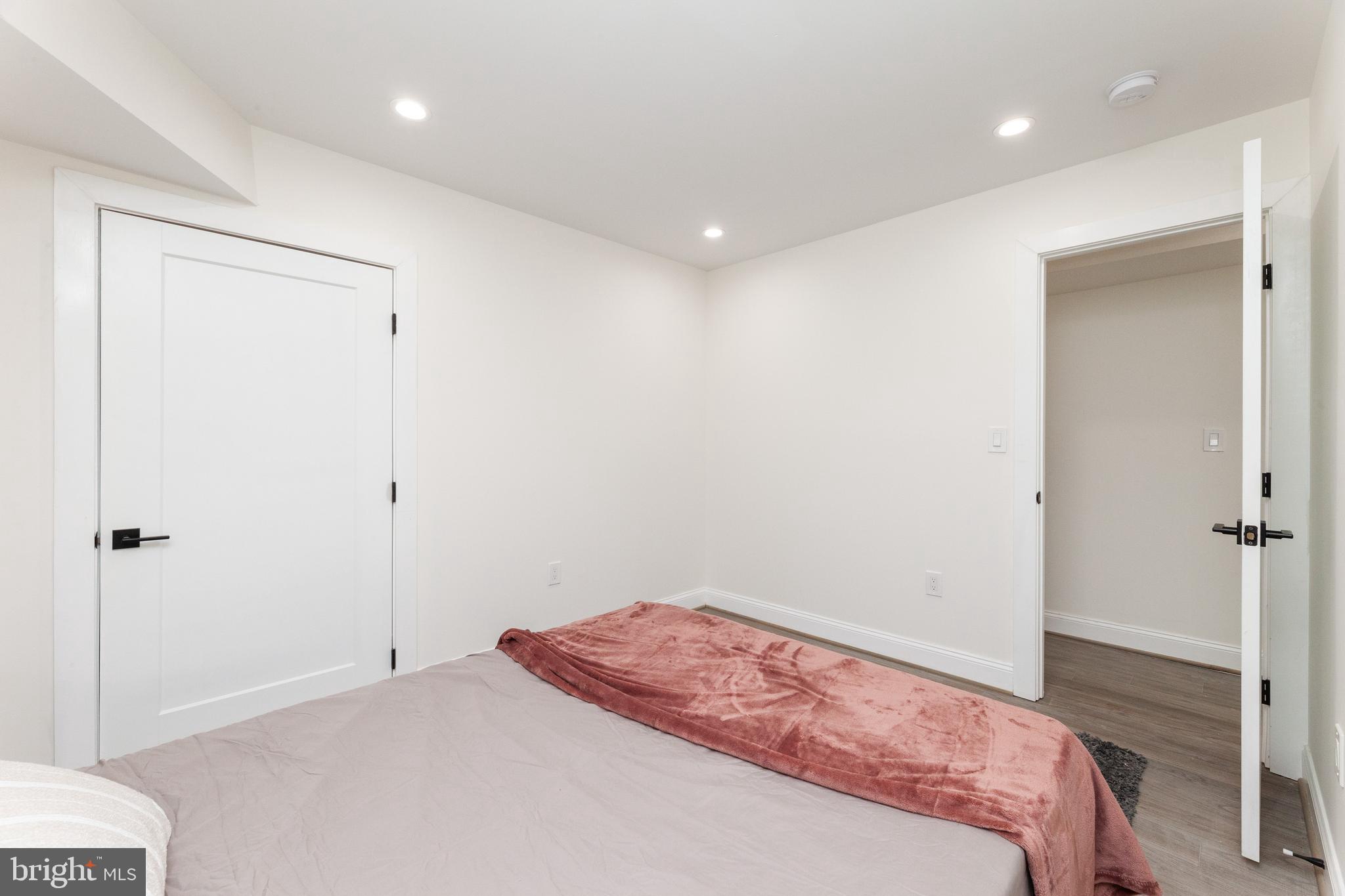 734 Kenyon Street Northwest, Unit 2 Washington, DC 20010 - Photo 13 of 24 a bedroom with a bed and hallway