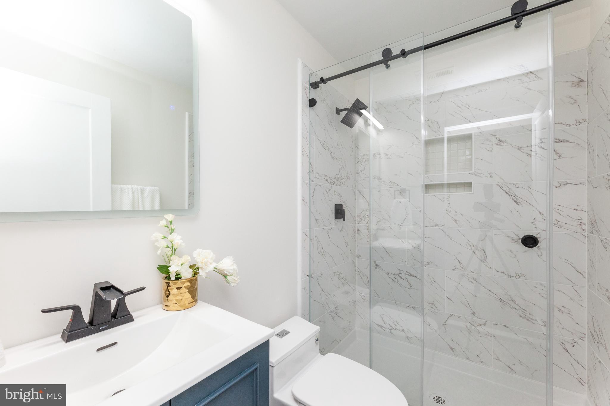 734 Kenyon Street Northwest, Unit 2 Washington, DC 20010 - Photo 14 of 24 a bathroom with a sink toilet and shower