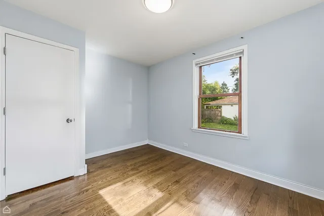a view of a livingroom with wooden floor and window