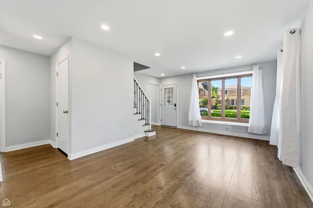a view of room with wooden floor and window