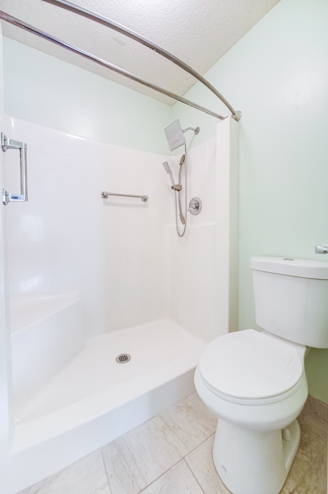 200 Sanders Ferry Road, Unit 1209 Hendersonville, TN 37075 - Photo 18 of 27 a white toilet sitting next to a bath tub and shower
