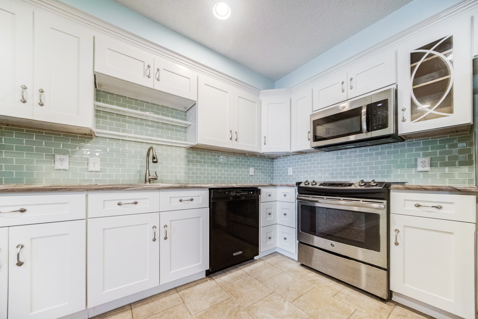 200 Sanders Ferry Road, Unit 1209 Hendersonville, TN 37075 - Photo 9 of 27 a kitchen with granite countertop white cabinets stainless steel appliances and a sink