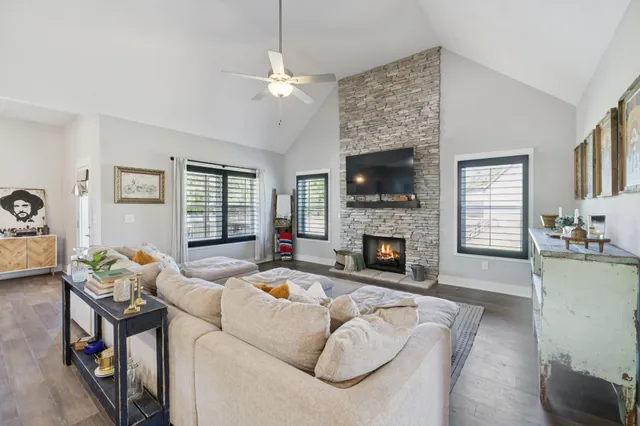 a living room with furniture fireplace and flat screen tv