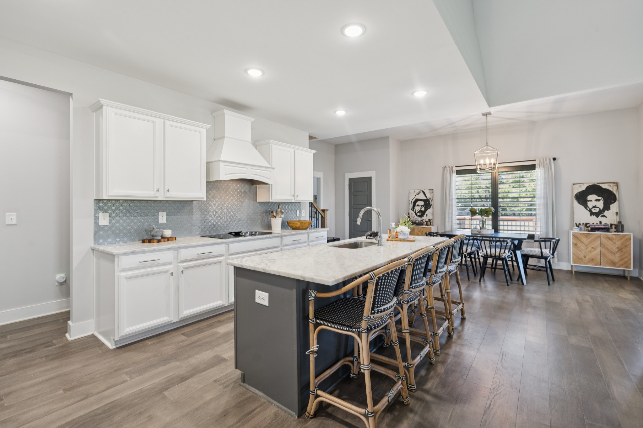 12725 North Milton Road Milton, TN 37118 - Photo 15 of 54 a kitchen with stainless steel appliances granite countertop a stove a refrigerator a sink a dining table and chairs with wooden floor