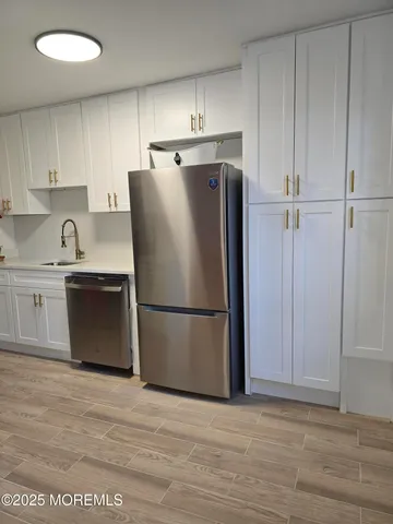 a white refrigerator freezer sitting in a kitchen
