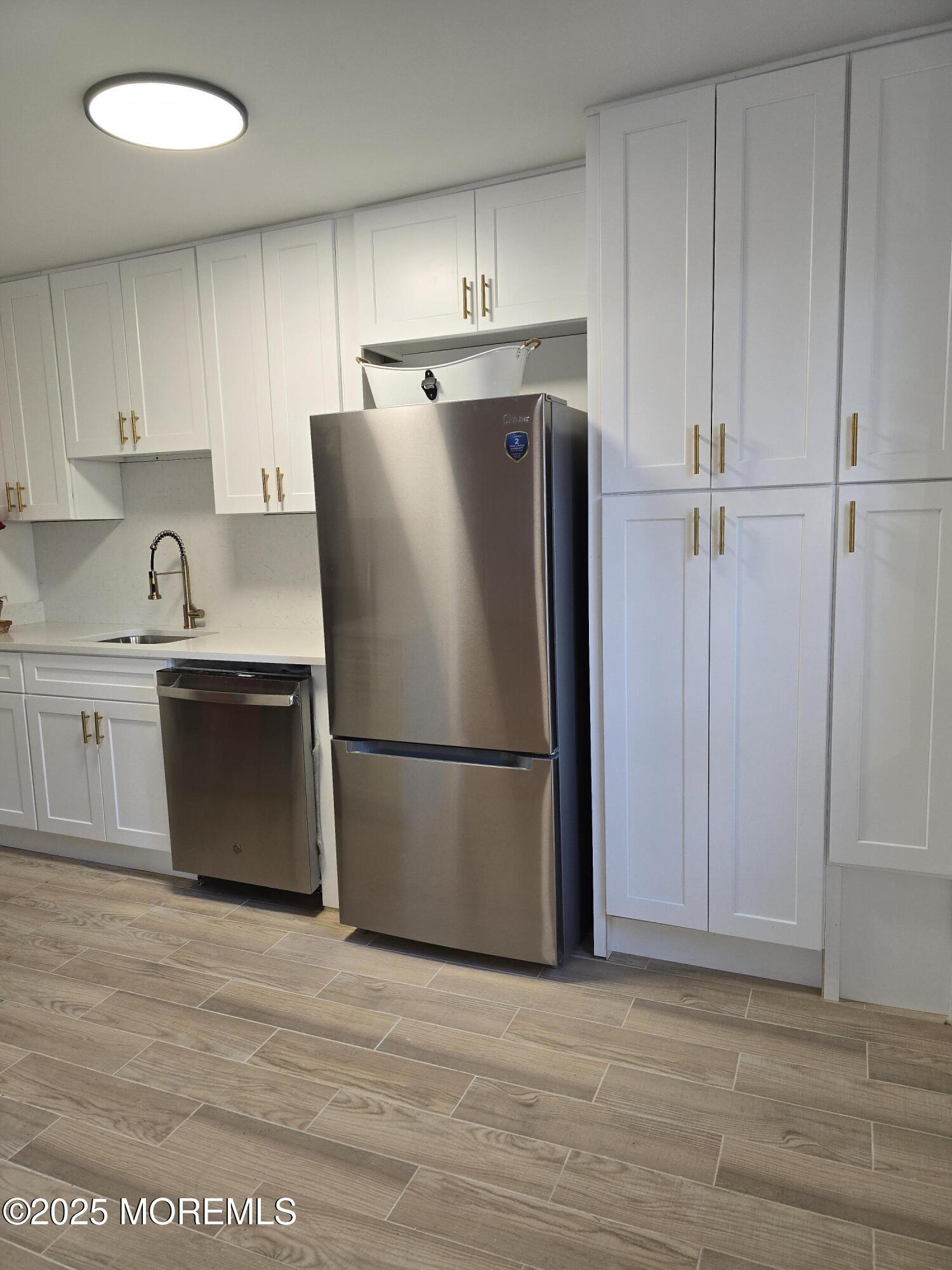142 South Street, Unit 10B Red Bank, NJ 07701 - Photo 4 of 9 a white refrigerator freezer sitting in a kitchen