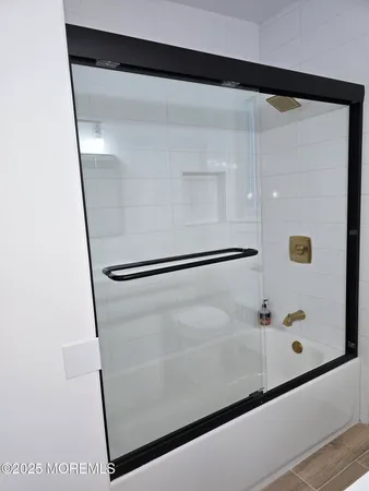 a bathroom with a shower and a mirror