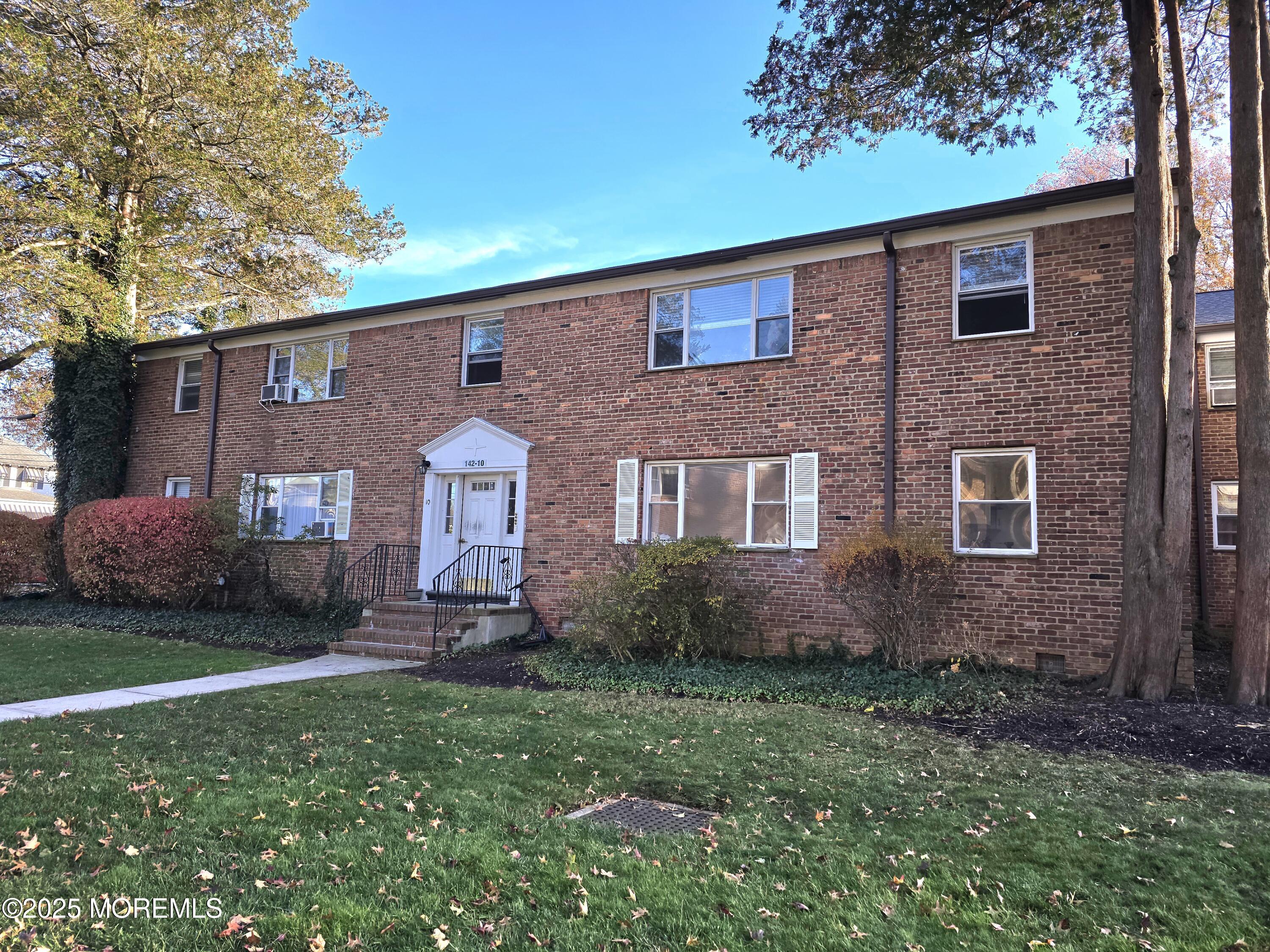 142 South Street, Unit 10B Red Bank, NJ 07701 - Photo 9 of 9 a front view of a house with a yard and garage