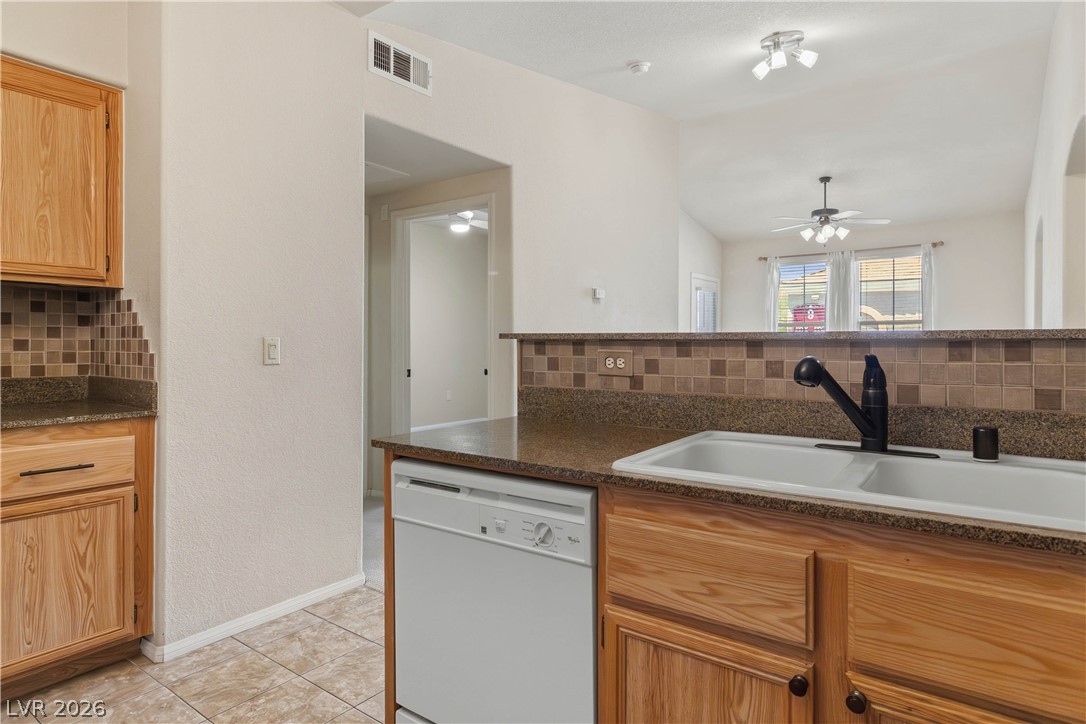10550 West Alexander Road, Unit 2060 Las Vegas, NV 89129 - Photo 18 of 45 Functional kitchen with ample counter space and a convenient breakfast bar opening to the living area.