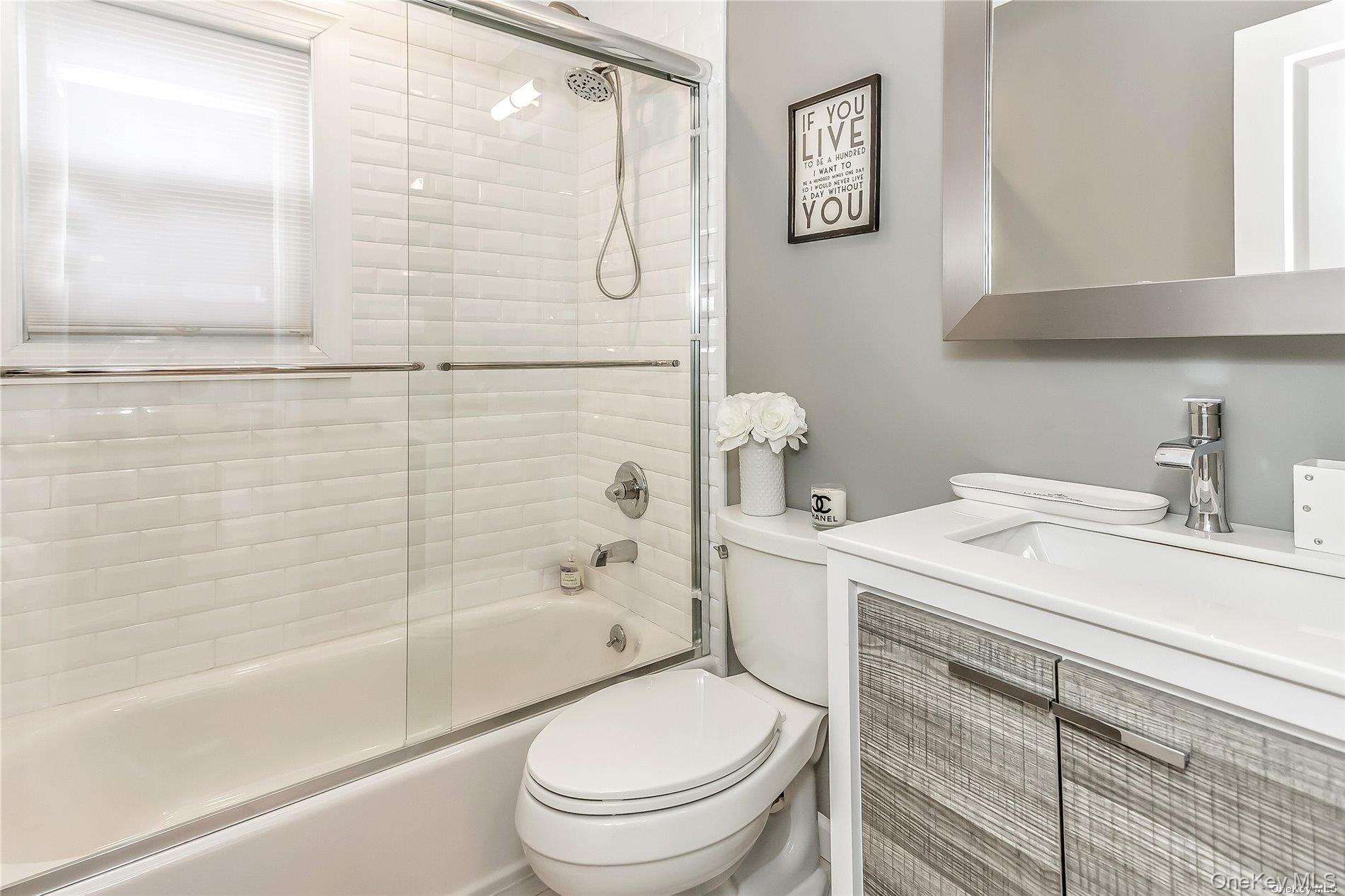 127 Maple Boulevard Long Beach, NY 11561 - Photo 11 of 22 a bathroom with a sink a toilet and a bathtub
