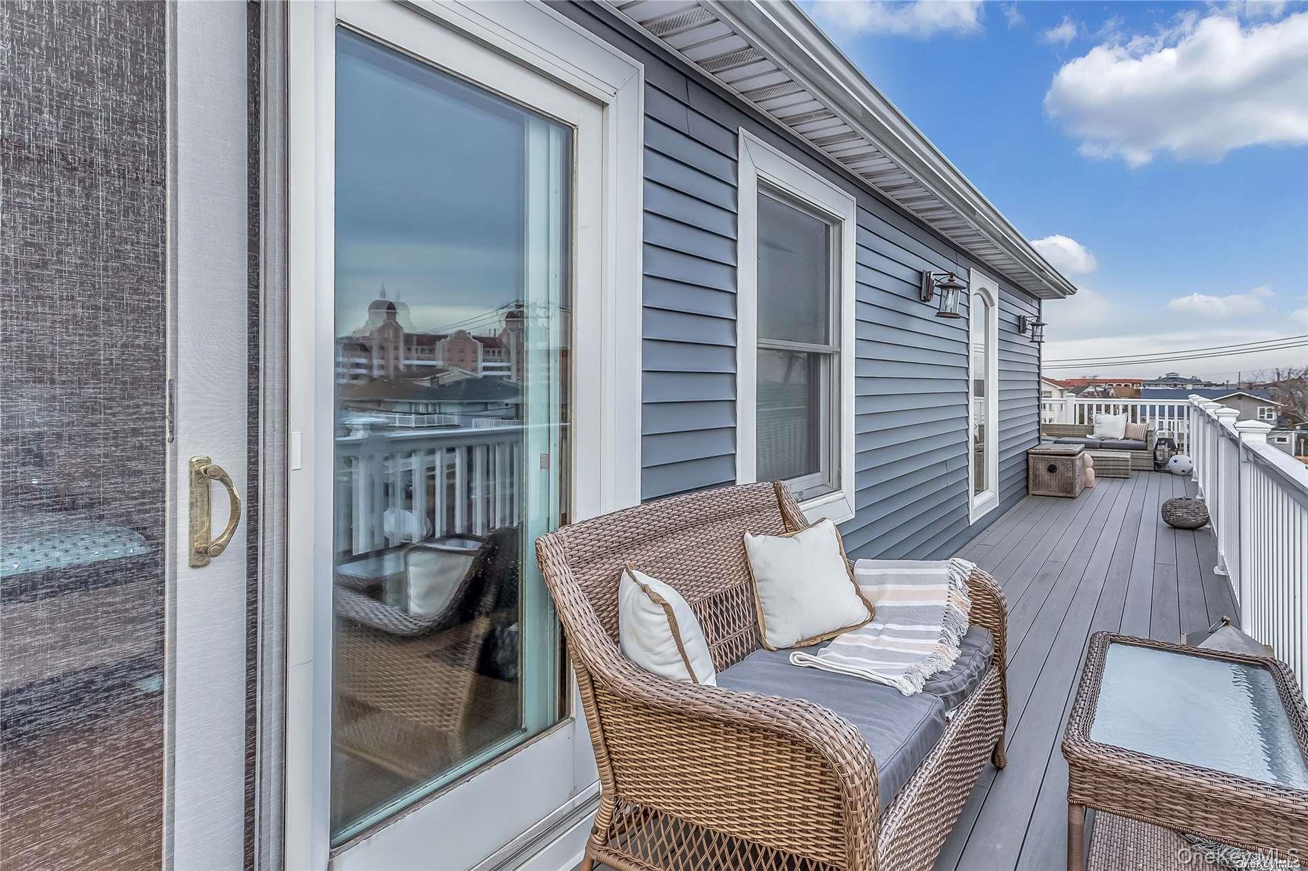 127 Maple Boulevard Long Beach, NY 11561 - Photo 12 of 22 a balcony with furniture and wooden floor