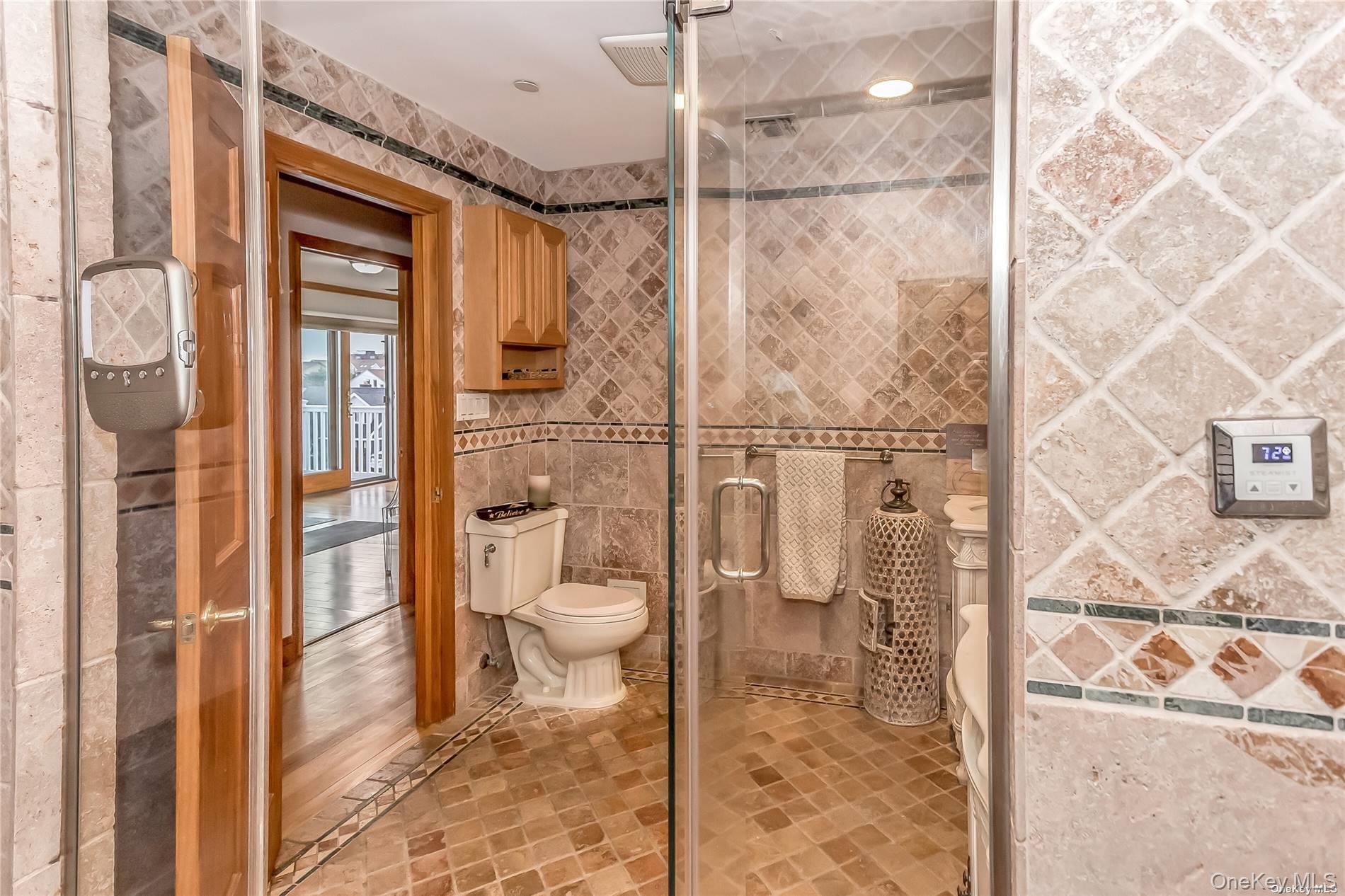 127 Maple Boulevard Long Beach, NY 11561 - Photo 17 of 22 a bathroom with a toilet and a shower