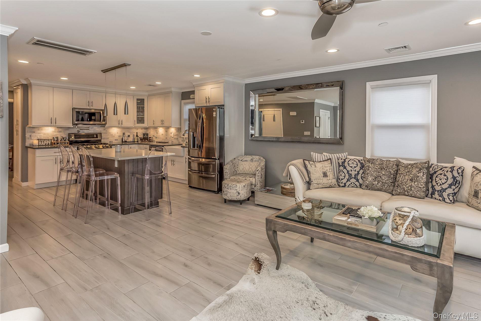 127 Maple Boulevard Long Beach, NY 11561 - Photo 4 of 22 a living room with furniture and a large window