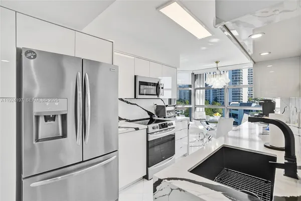 a kitchen with stainless steel appliances a refrigerator sink and stove