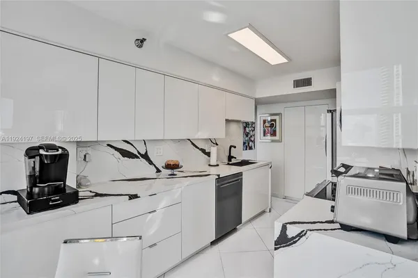 a kitchen with a sink appliances and cabinets