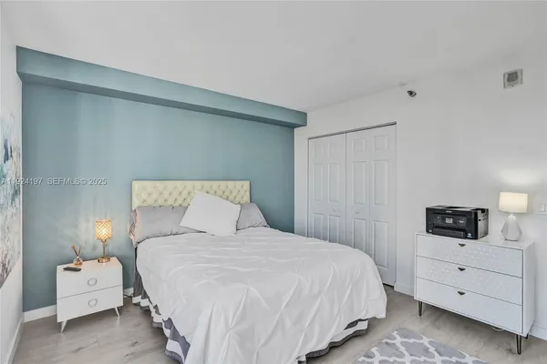 a bedroom with a bed and a night stand