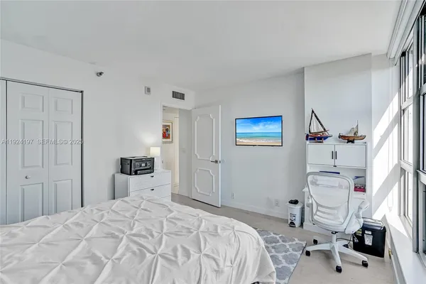 a bedroom with a bed and a couch