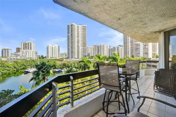 a view of balcony with chairs and potted plant