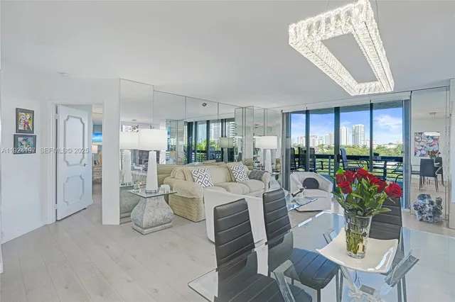 a living room with furniture ceiling fan and a large window