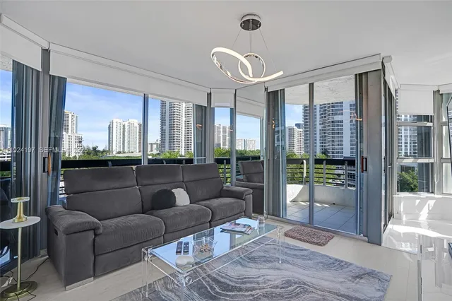 a kitchen with stainless steel appliances a stove a refrigerator cabinets and a dining table