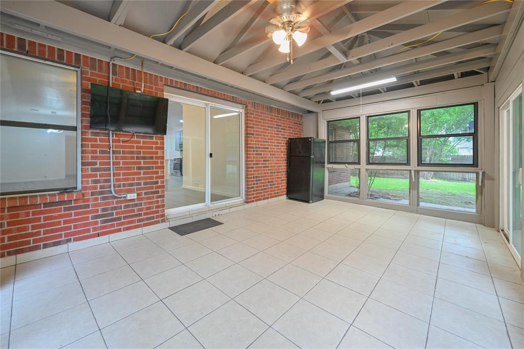 910 Rocking Spur Cove Pflugerville, TX 78660 - Photo 13 of 17 A versatile enclosed patio space offers seamless indoor-outdoor living, perfect for year-round enjoyment.