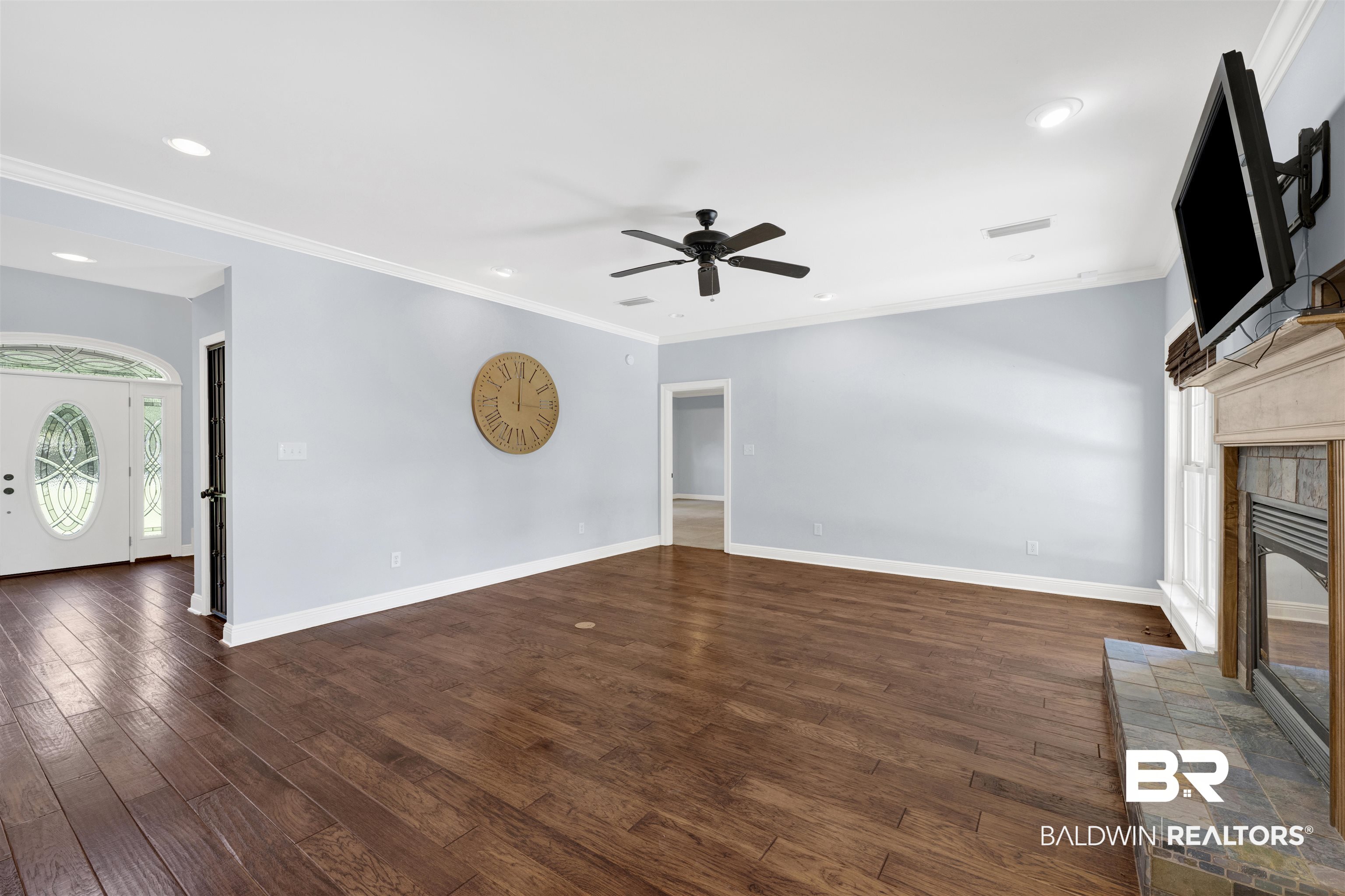 12944 Anna's Way Stapleton, AL 36578 - Photo 36 of 64 Spacious living area featuring wood-finish flooring, light blue walls, and a recessed lighting