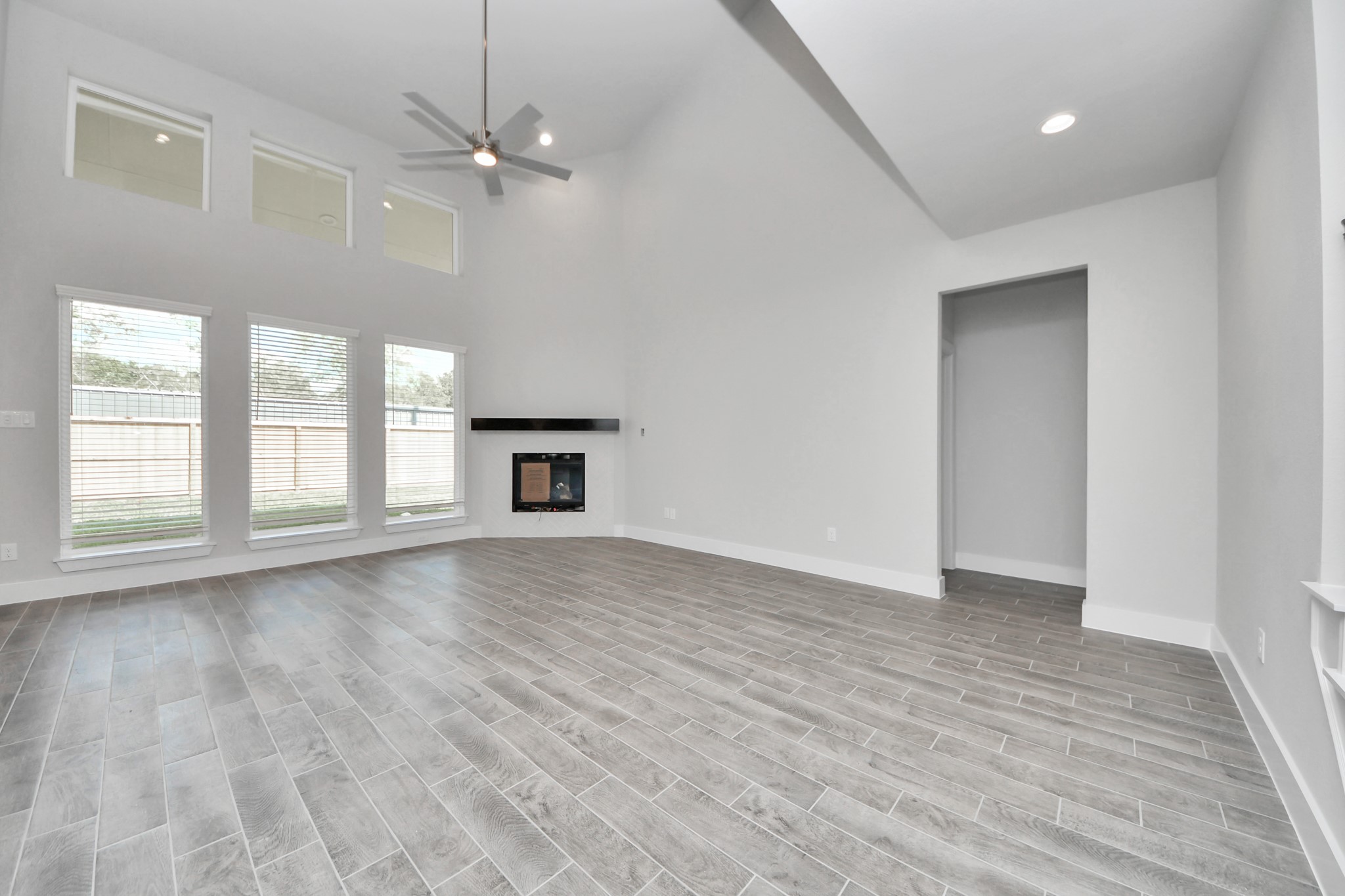 3110 Native Spg Drive Spring, TX 77373 - Photo 13 of 34 Welcome family and guests to your charming living room! With its high ceilings, recessed lighting, ceiling fan, custom paint, beautiful flooring, and large windows that let in abundant natural light, this room is perfect for gatherings. Sample photo of completed home with similar floor plan. Actual colors and selections may vary.