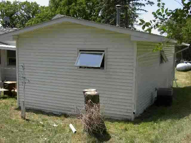77 North Dakota Road Ridott, IL 61067 - Photo 6 of 8 a backyard of a house with lots of green space