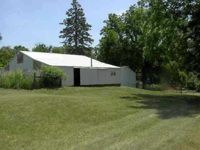 77 North Dakota Road Ridott, IL 61067 - Photo 8 of 8 a backyard of a house with plants and large trees
