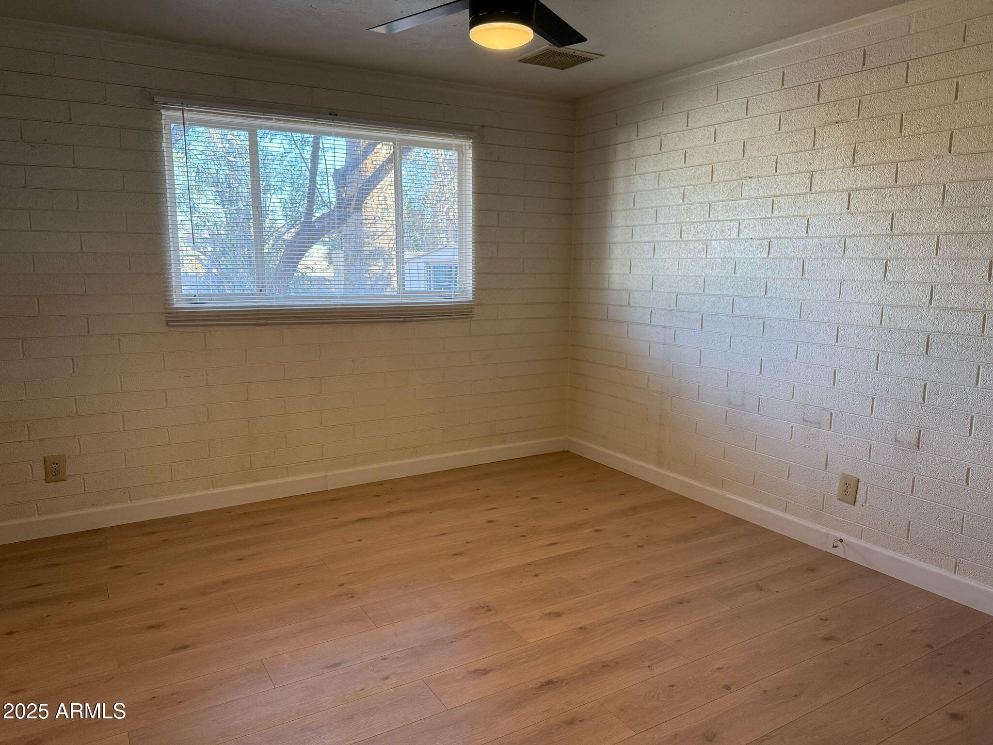 5000 West Osborn Road Phoenix, AZ 85031 - Photo 18 of 23 wooden floor in an empty room with a window