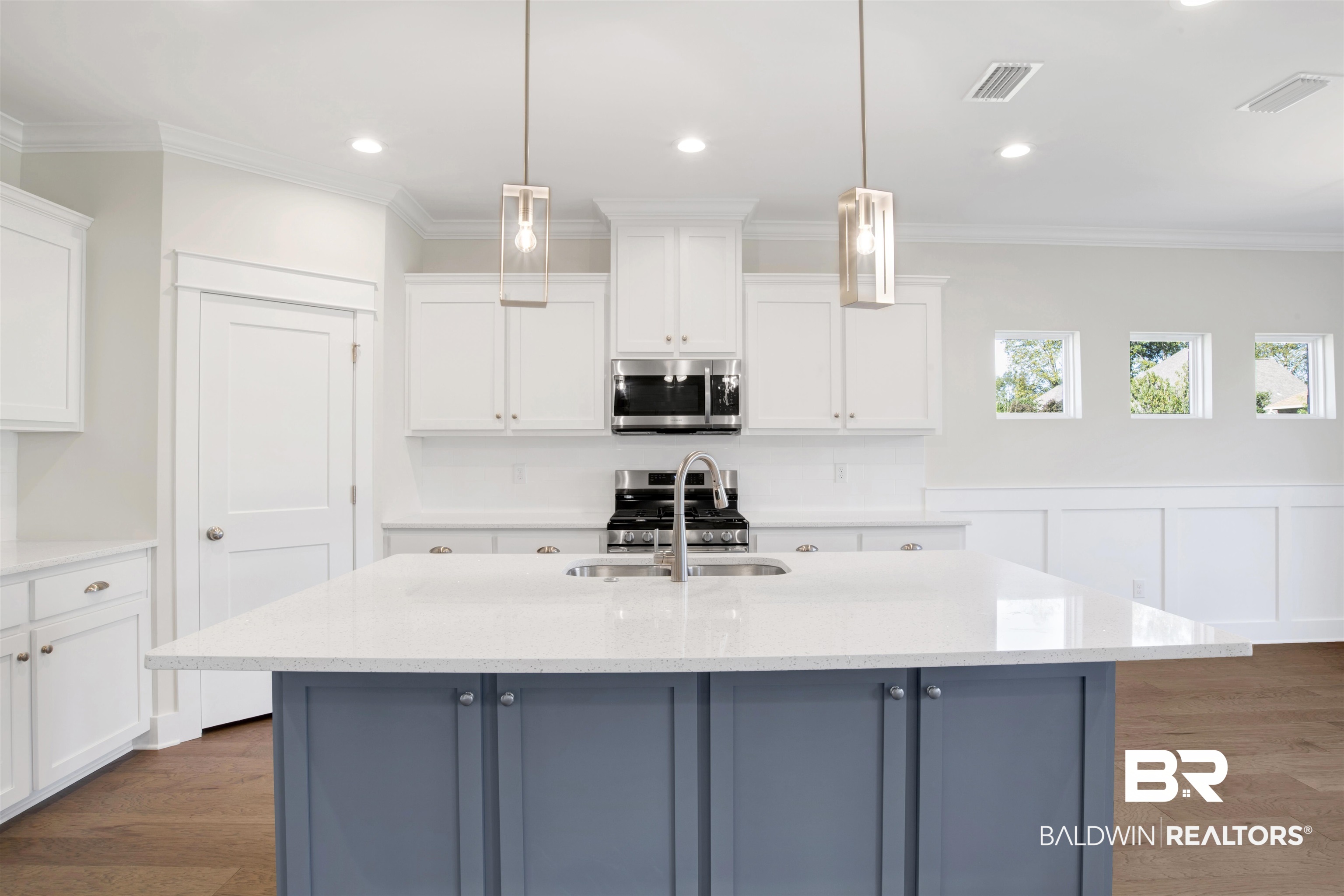 9687 Widgeon Court Daphne, AL 36526 - Photo 10 of 40 Kitchen with appliances with stainless steel finishes, white cabinetry, and hanging light fixtures