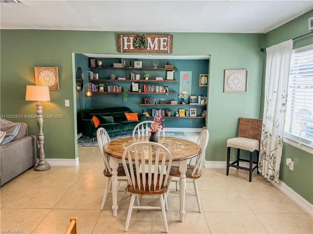 a dining room with furniture and window