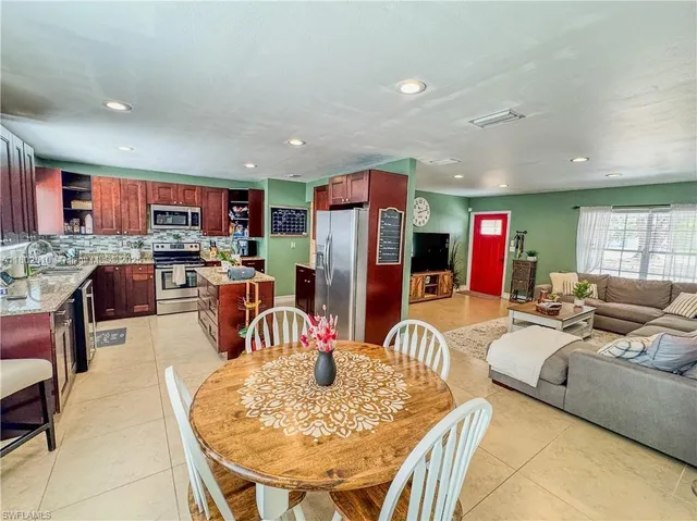 a living room with fireplace furniture and a dining table