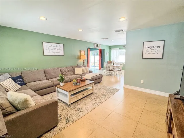 a living room with furniture and a rug