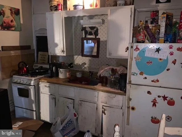 a kitchen with a refrigerator and a stove