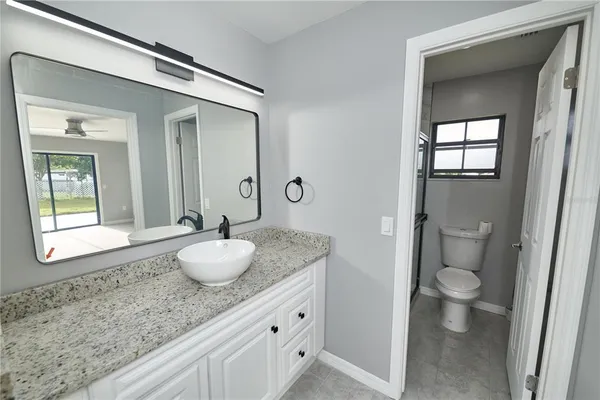a white toilet sitting next to a window