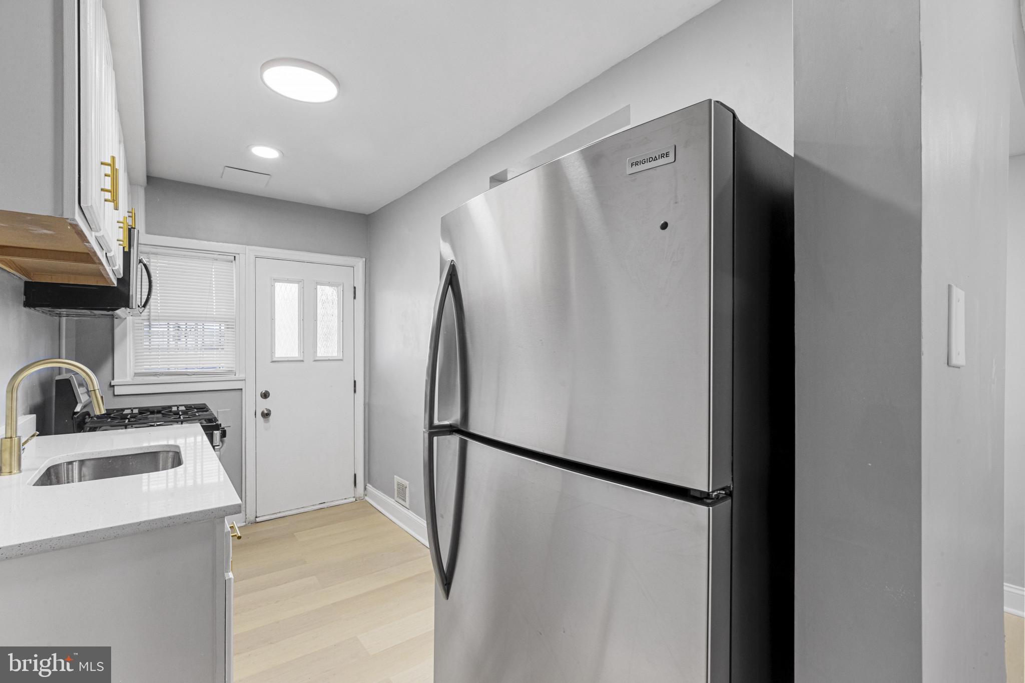 105 Upmanor Road Baltimore, MD 21229 - Photo 11 of 27 a view of a kitchen with a sink and refrigerator