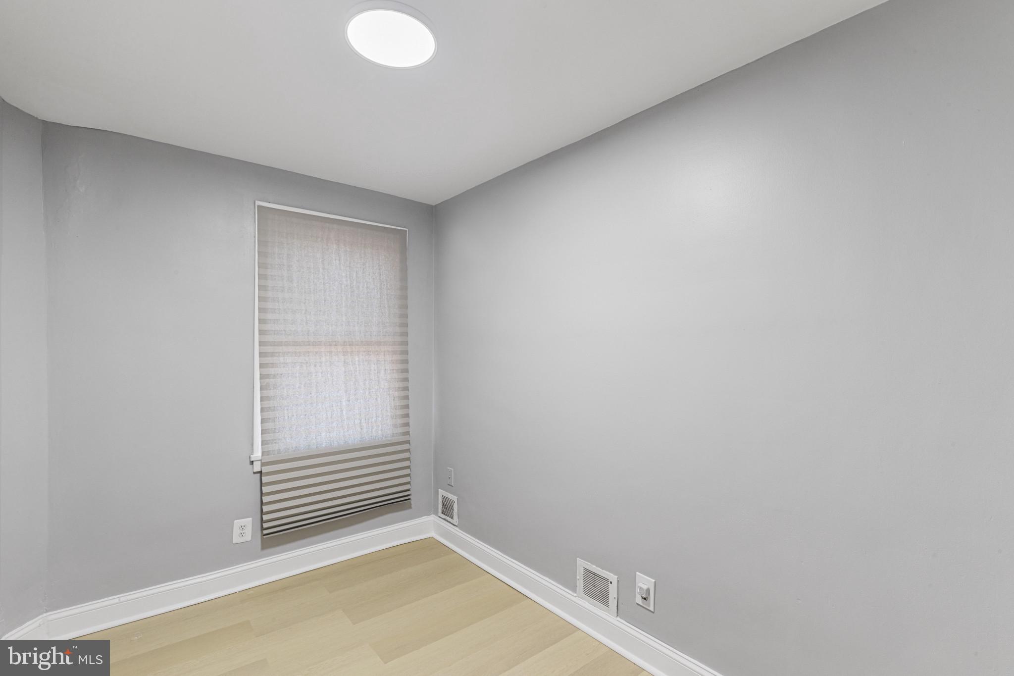 105 Upmanor Road Baltimore, MD 21229 - Photo 20 of 27 a view of a room with wooden floor and white walls