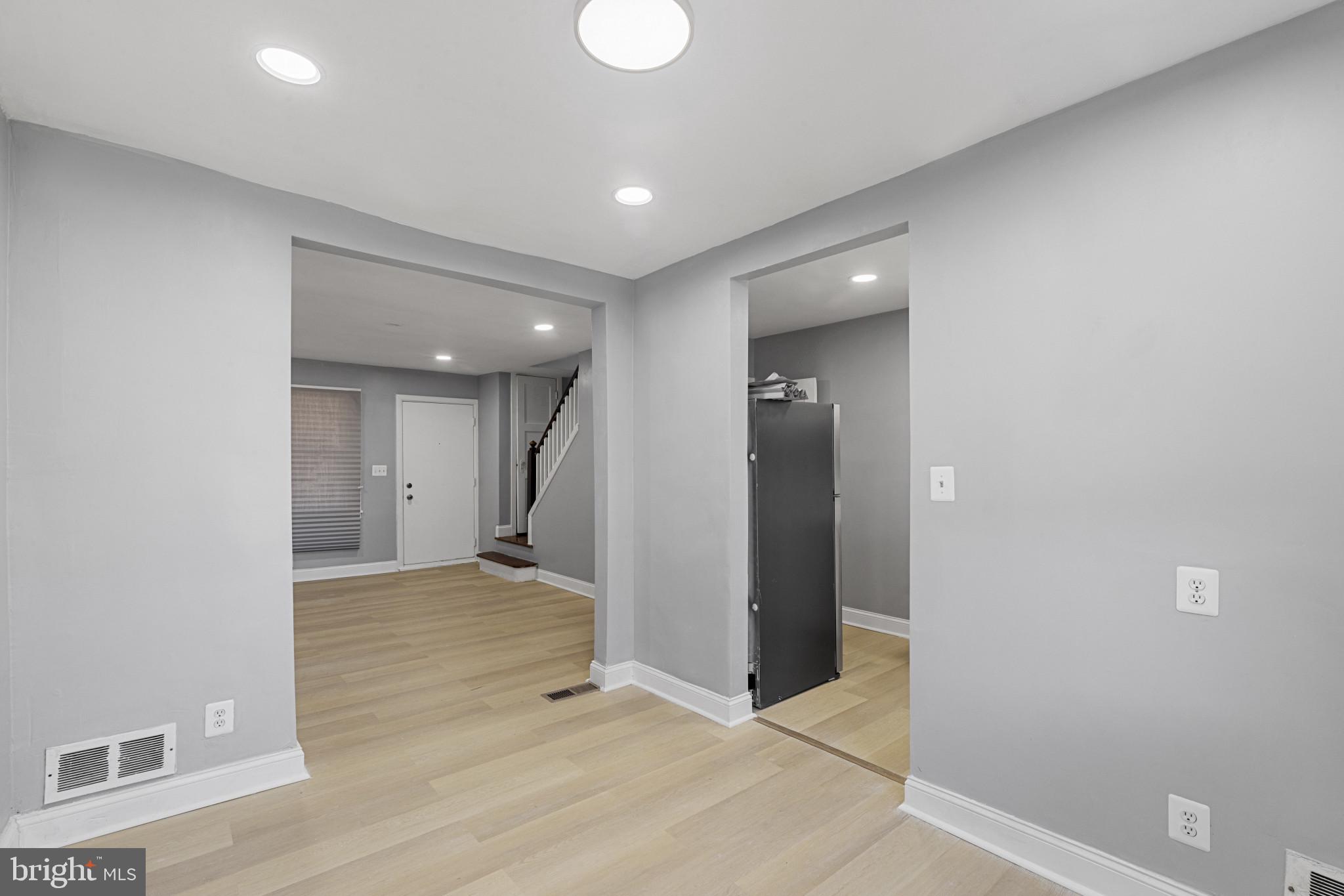 105 Upmanor Road Baltimore, MD 21229 - Photo 7 of 27 an empty room with wooden floor and windows