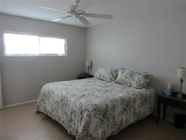 a bed sitting in a bedroom next to a window