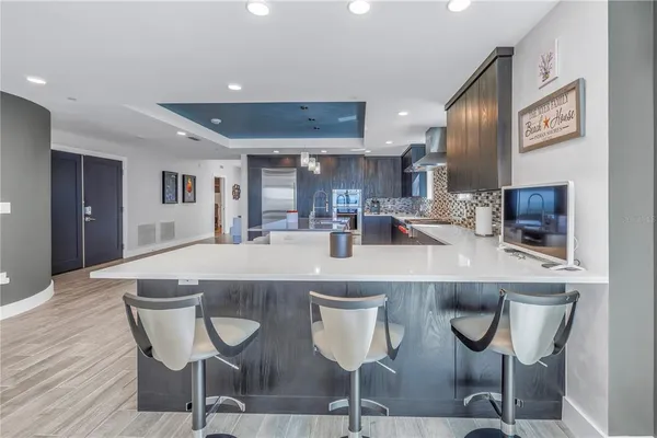 a kitchen with cabinets and chairs