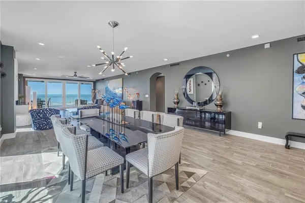 a view of a dining room with furniture and a kitchen