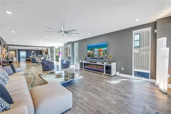 a living room with furniture and a wooden floor