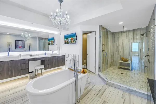 a spacious bathroom with a tub shower and mirror